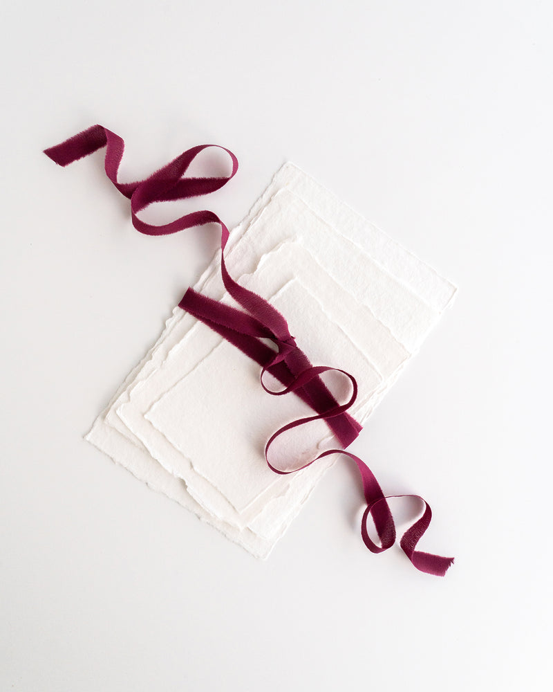 Tono + co Silk Ribbon Trim in Berry. Perfect for stationary styling, boutonnieres, and detail work. Find your inspiration through color and silk. Lovingly hand-dyed in Santa Ana, California and available in 24 signature colors. Check out our website for more styling, flat-lay, and color tips.