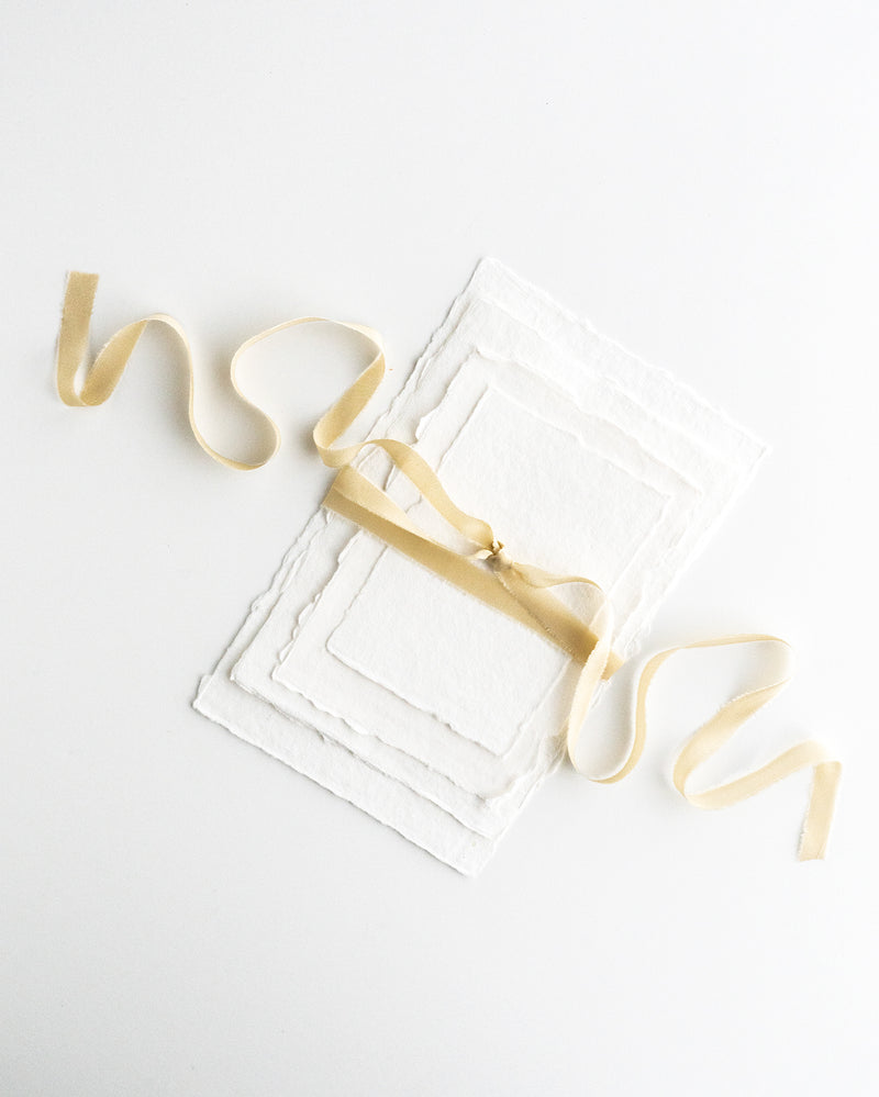 Tono + co Silk Ribbon Trim in Cream. Perfect for stationary styling, boutonnieres, and detail work. Find your inspiration through color and silk. Lovingly hand-dyed in Santa Ana, California and available in 24 signature colors. Check out our website for more styling, flat-lay, and color tips.